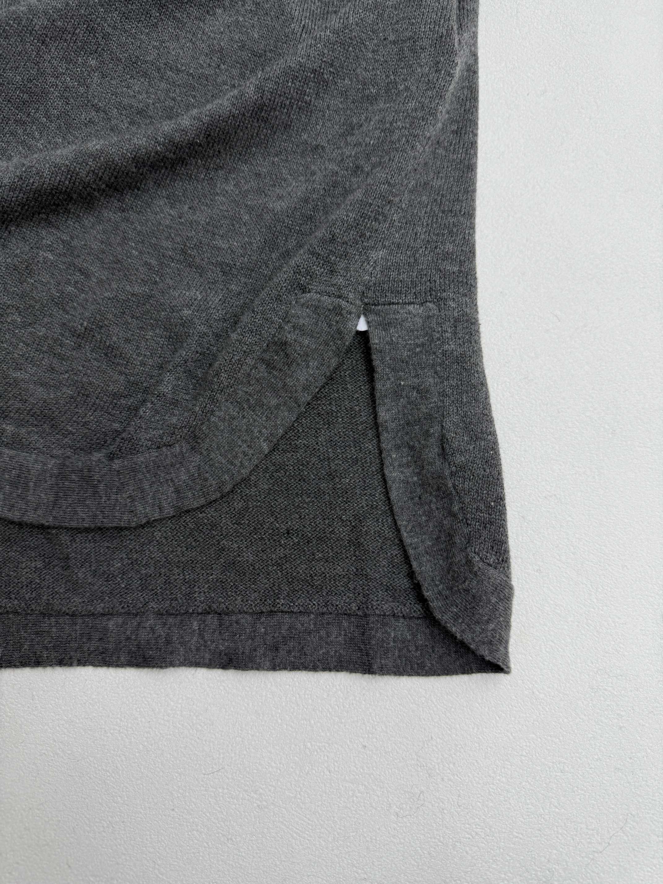 Heather gray polo shirt side hem with stitched seam and drape detail