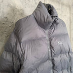 Gray Balenciaga puffer jacket side view with zip seam and small chest logo.
