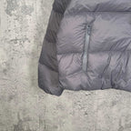 Gray Balenciaga puffer jacket hem with zip pocket and quilted puffer fabric.