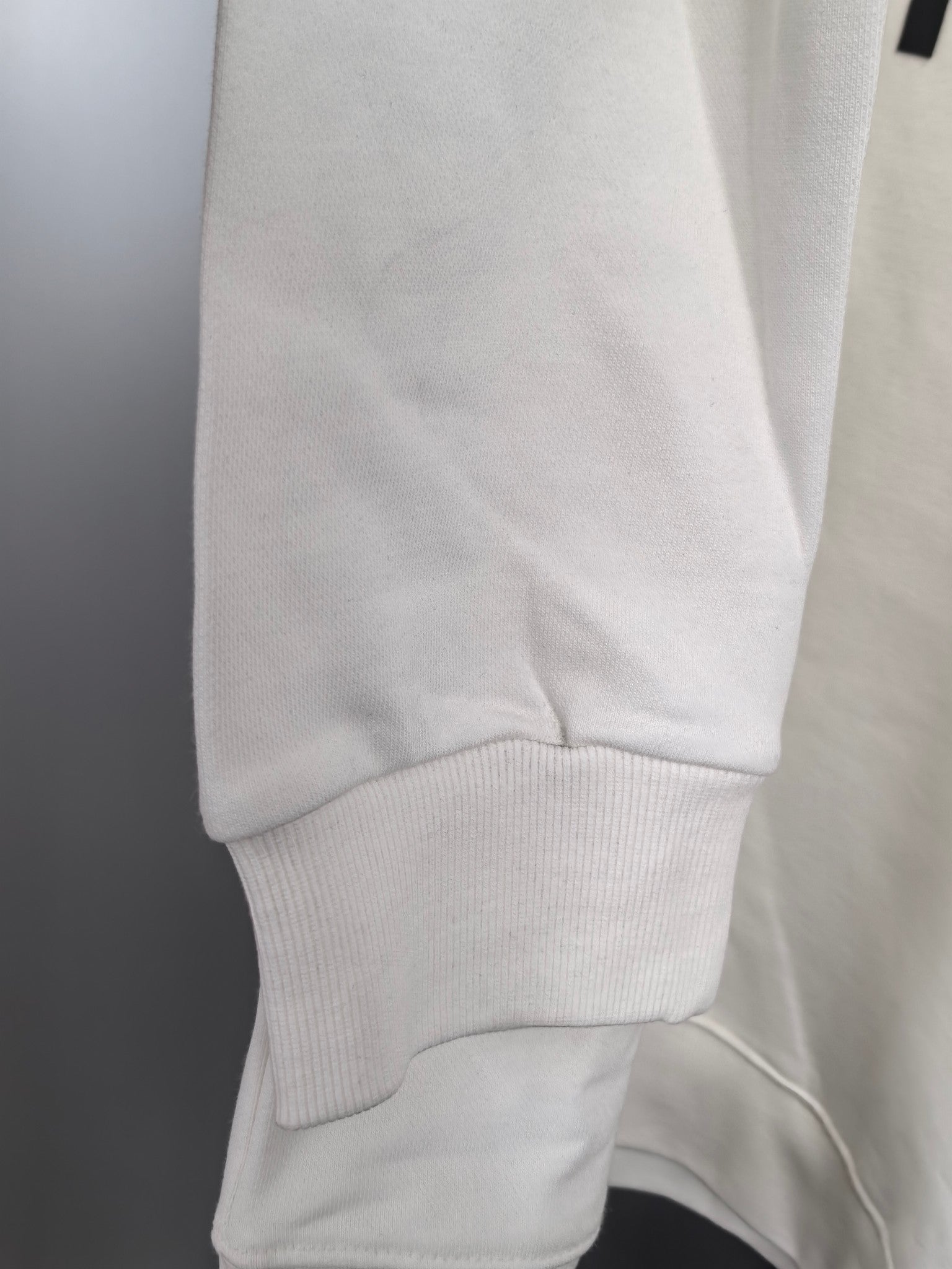 White sweatshirt cuff and hem with ribbed knit finish