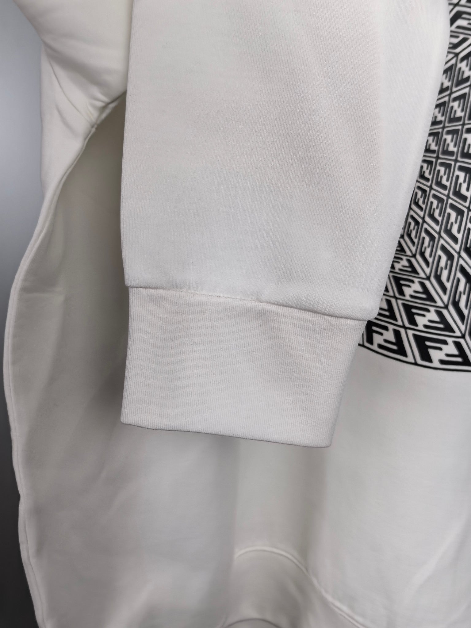 White sweatshirt sleeve cuff and hem with clean stitched finish