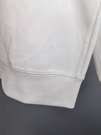 White sweatshirt hem with double-stitched cuff detail