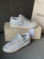 Golden Goose light blue low-top sneakers on box, lace-up with side perforation details