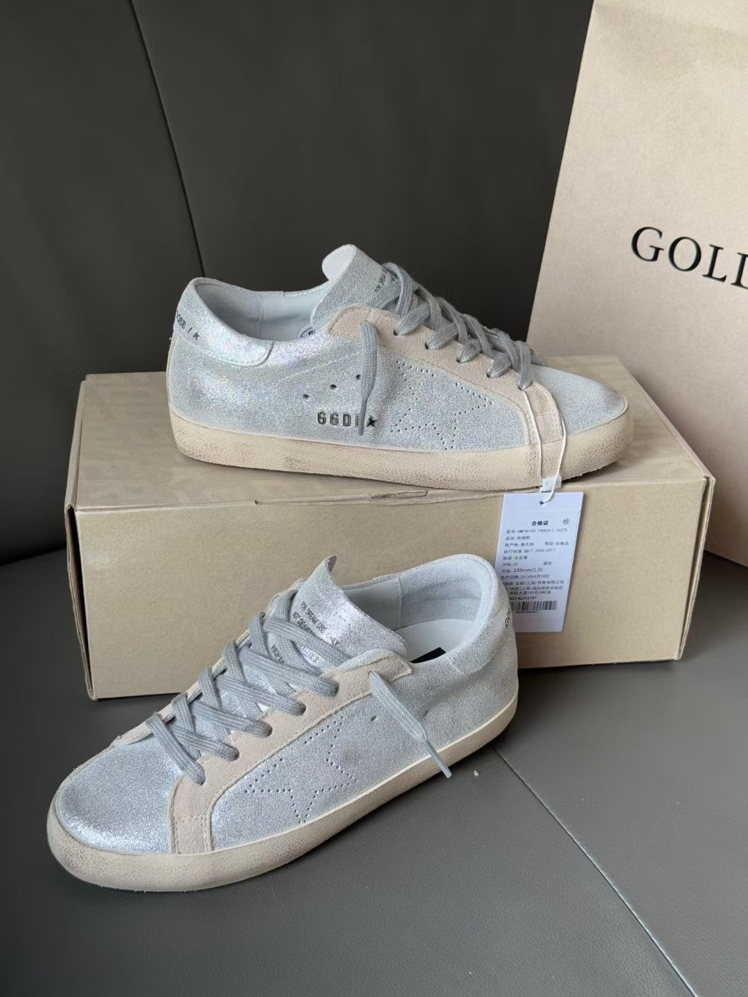 Golden Goose light blue low-top sneakers on box, lace-up with side perforation details