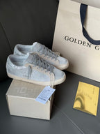 Golden Goose light blue low-top sneakers with gray laces and white rubber soles