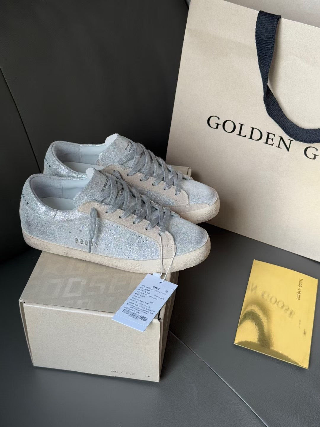 Golden Goose light blue low-top sneakers with gray laces and white rubber soles