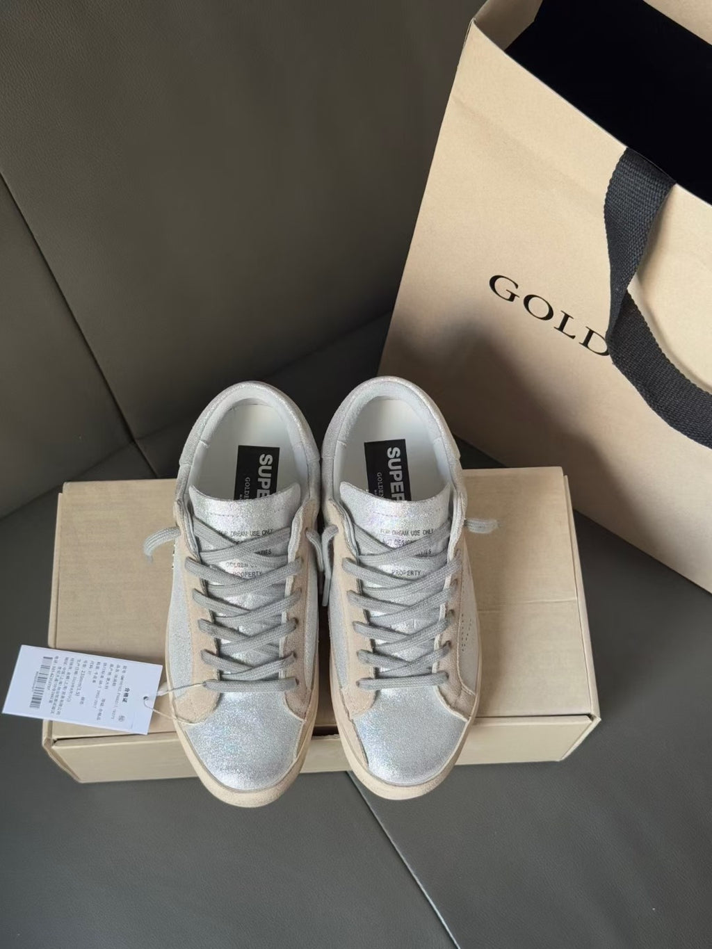 Golden Goose light blue lace-up sneakers on shoebox, white rubber soles and black label