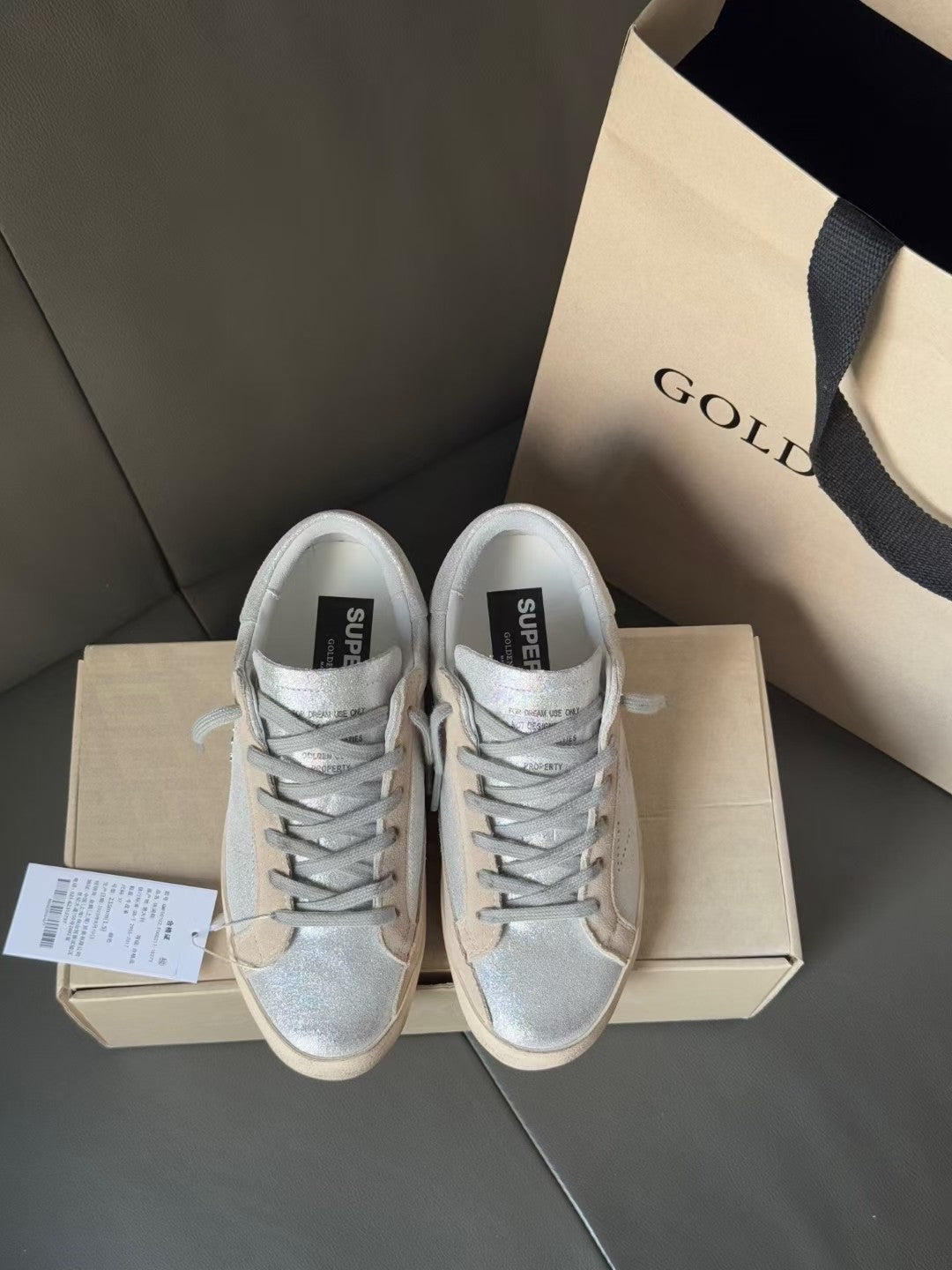 Golden Goose light blue lace-up sneakers on shoebox, white rubber soles and black label