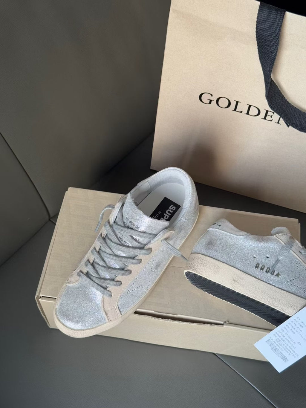 Golden Goose light blue suede sneakers on shoebox, lace-up with stitched panels