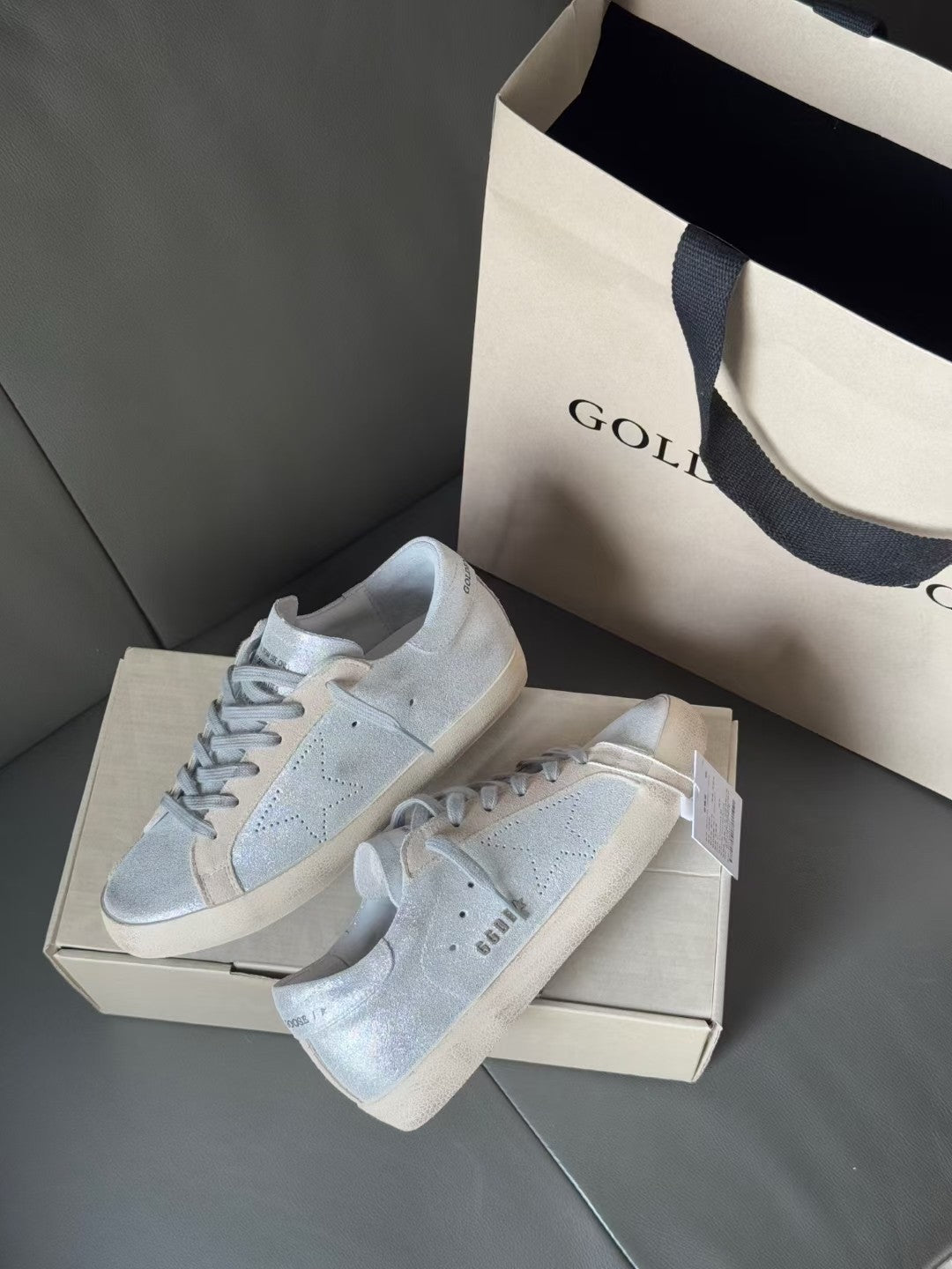 Golden Goose light blue sneakers, front view, lace-up design with white toe caps