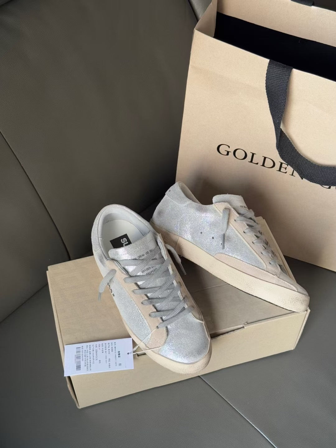 Golden Goose light blue low-top sneakers with white soles and visible product tag