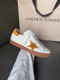Golden Goose low-top sneakers, white with gold star patch and orange-brown sole