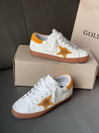 Golden Goose low-top sneakers, white with gold star and orange-brown sole