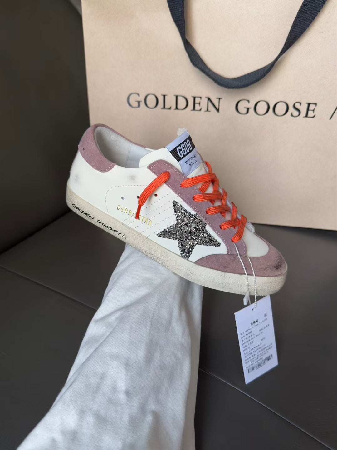 Golden Goose low-top sneakers, white with mauve panels, orange lace-up, star detail