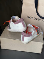 Golden Goose low-top sneakers heel view, mauve and white with orange laces, star panel