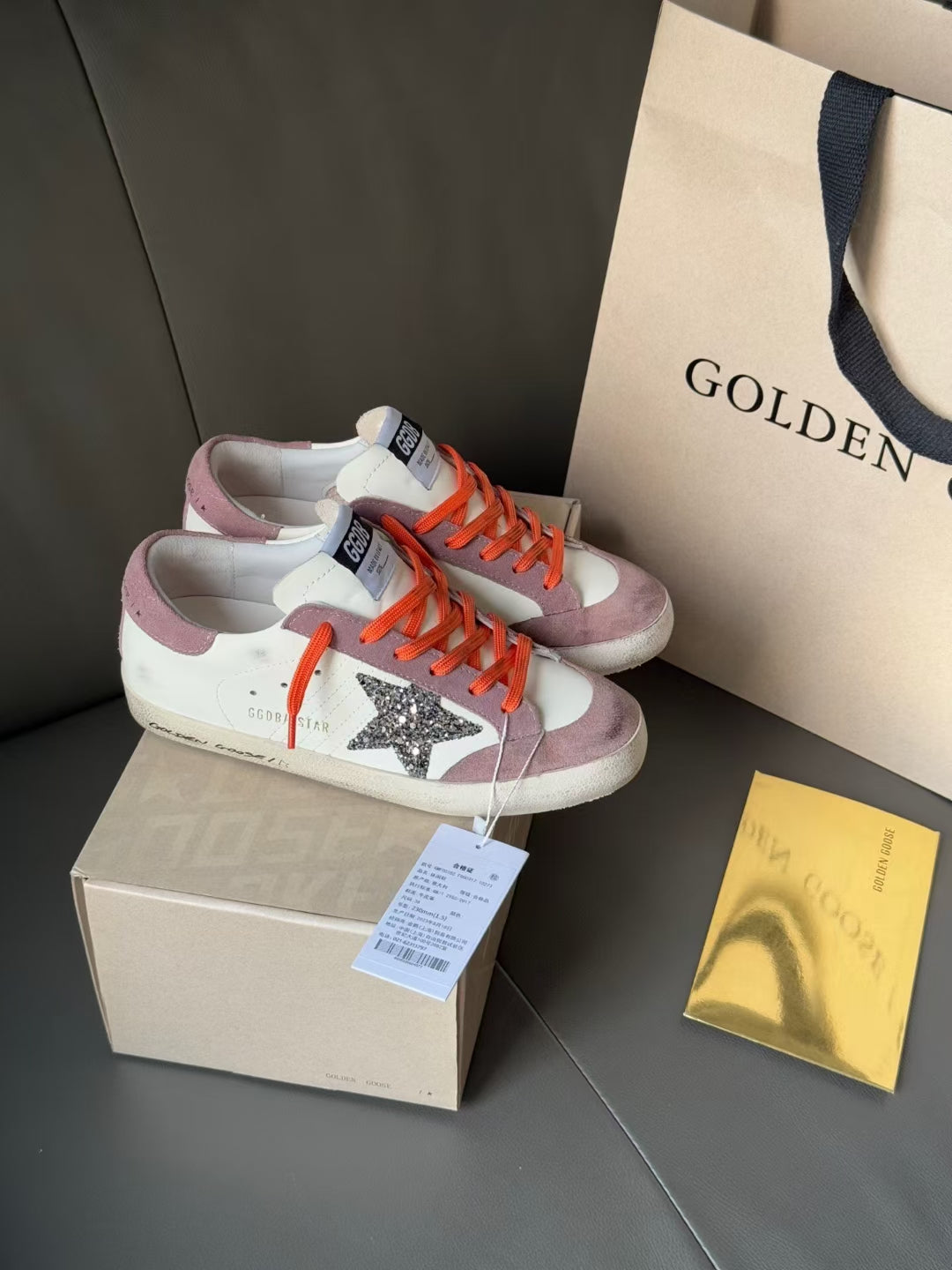 Golden Goose low-top sneakers with tags, white and mauve, orange laces, glitter star