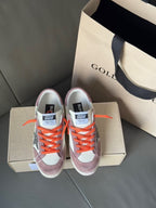 Golden Goose low-top sneakers front view, white/mauve uppers, orange laces, star logo