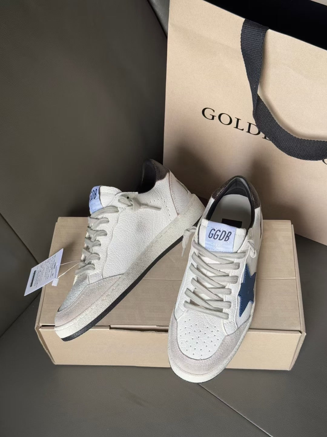 White sneakers with blue star patch, black collar, and white lace-up front