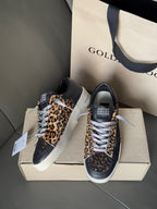 Golden Goose lace-up sneakers pair, navy with leopard-print sides and white laces