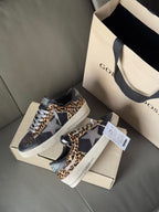 Low-top lace-up sneakers on shoebox, dark uppers with leopard-print side panels