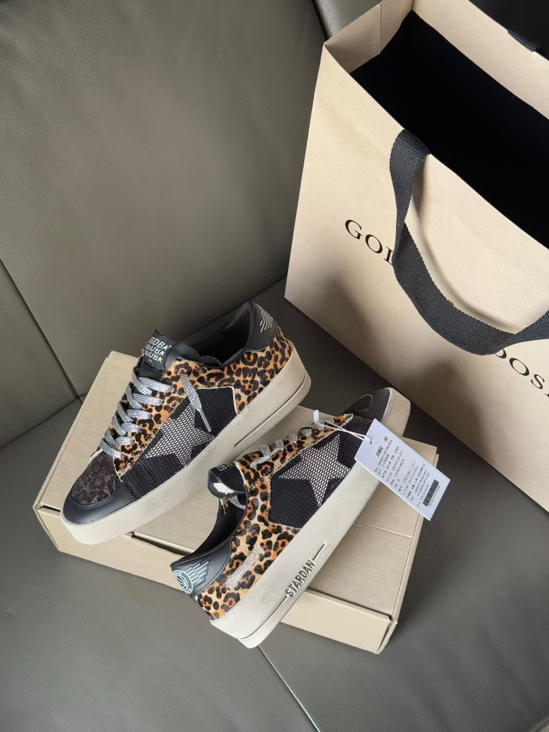 Low-top lace-up sneakers on shoebox, dark uppers with leopard-print side panels