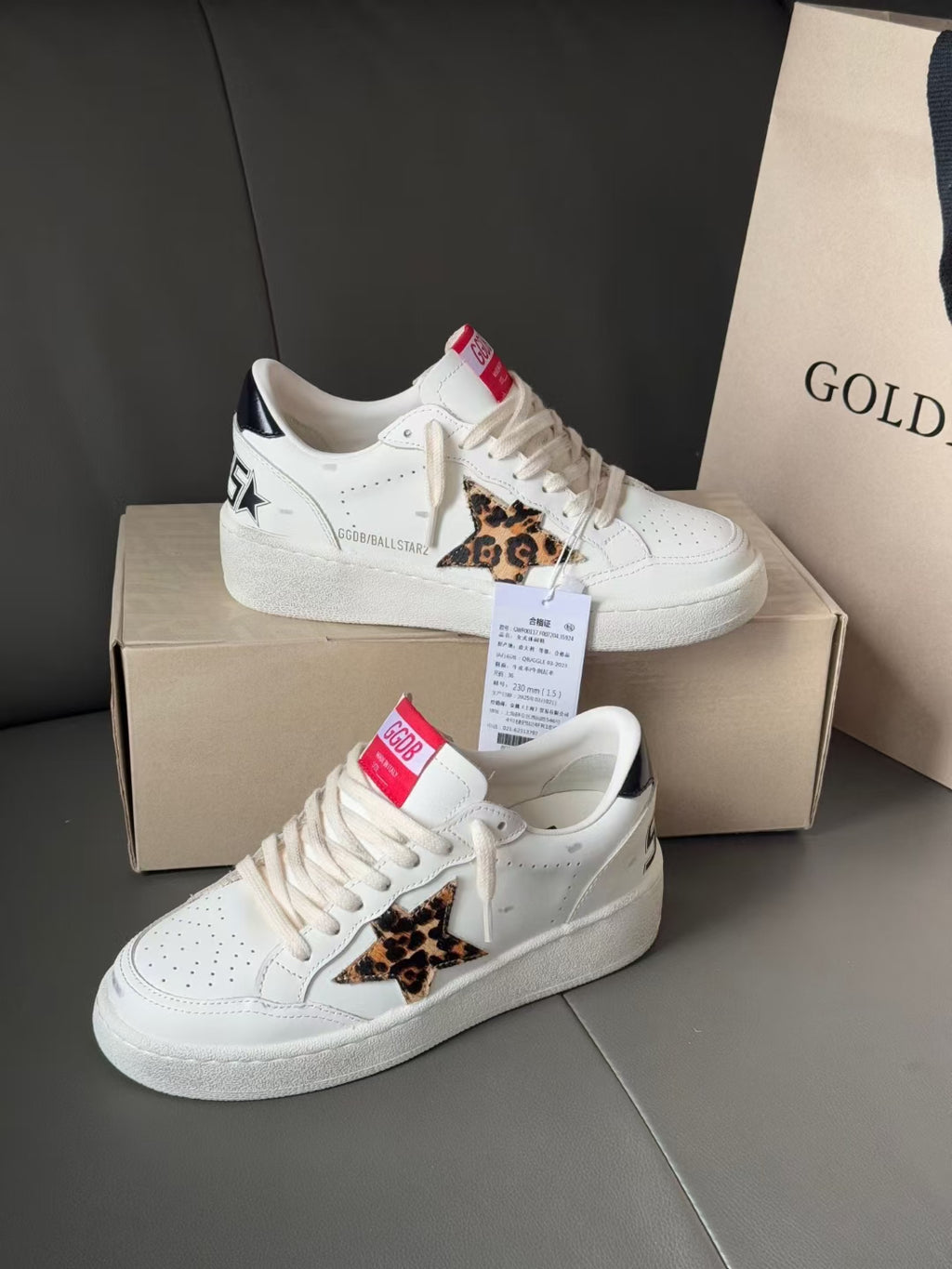 White leather sneakers with leopard side patch and lace-up front