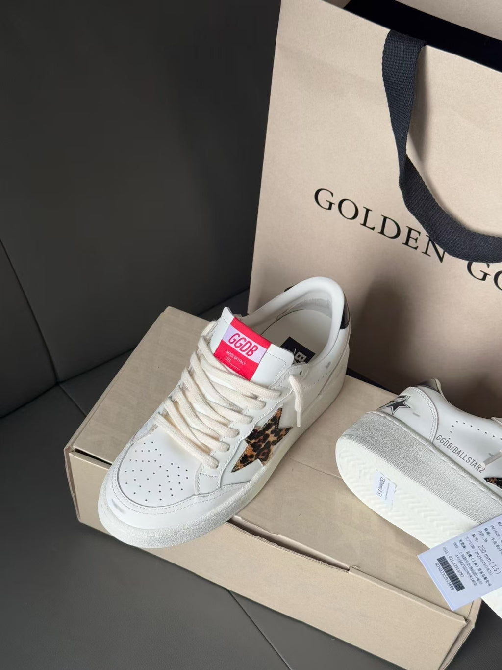 White leather sneakers with leopard panel and red tongue tag
