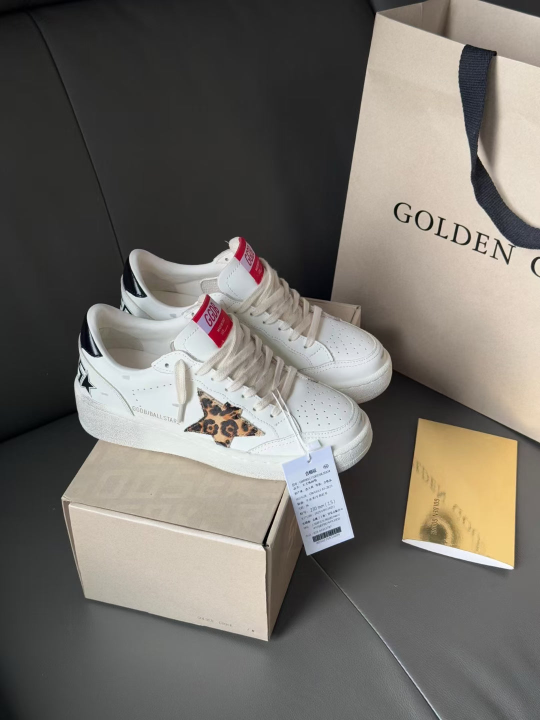 White leather sneakers with leopard patch and lace-up closure