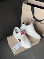 White leather sneakers with leopard patch and blue-red tongue labels
