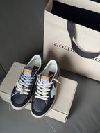 Low-top sneakers on shoebox, navy upper with white star, lace-up, gum sole