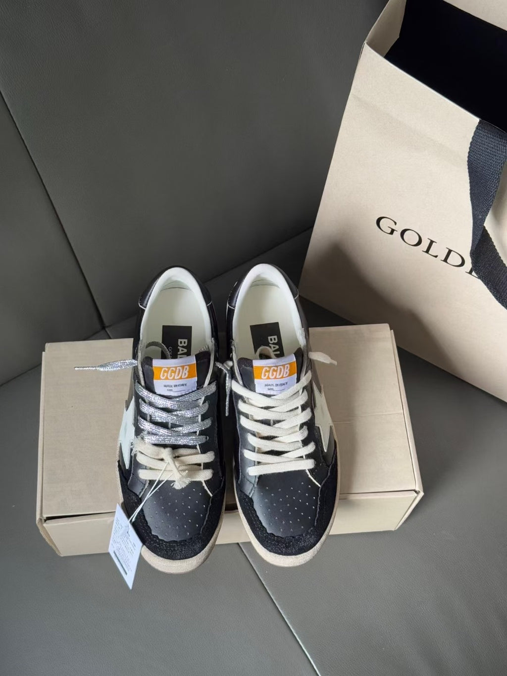 Rear view low-top sneakers, dark navy leather with gum sole, lace-up, in shoebox