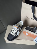 Low-top sneakers, navy upper with white star panel, lace-up, gum sole, on shoebox