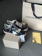 Low-top sneakers, dark navy with white star, lace-up with tag, gum sole beside shoebox