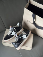 Low-top sneakers, dark navy with white star, lace-up, gum sole, on shoebox
