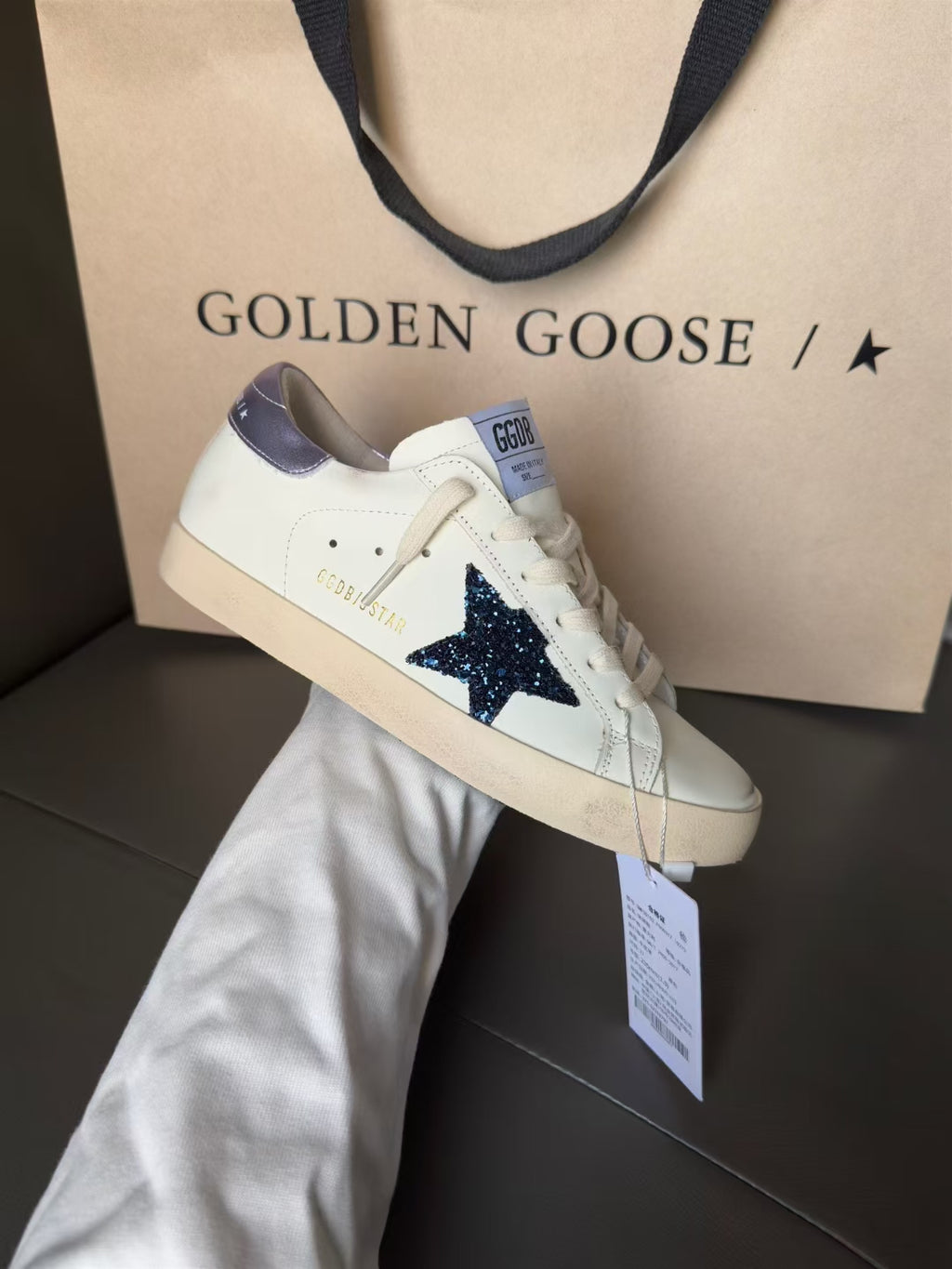 Luxury sneakers, white with navy star and lavender heel, lace-up