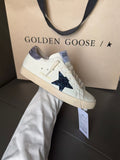 Luxury sneakers, white with navy star and lavender heel, lace-up
