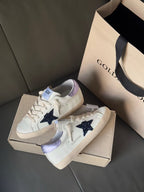 Two luxury sneakers, white leather look with navy star and lavender heel lining
