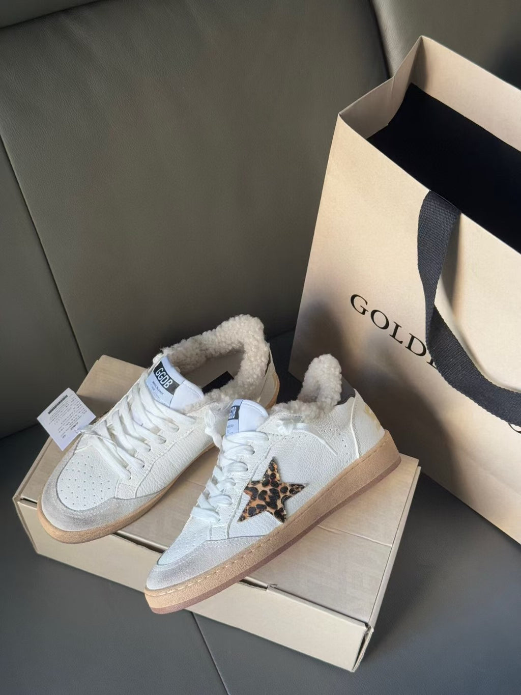 Golden Goose white sneakers with leopard detail on side, tan sole, plush sherpa lining