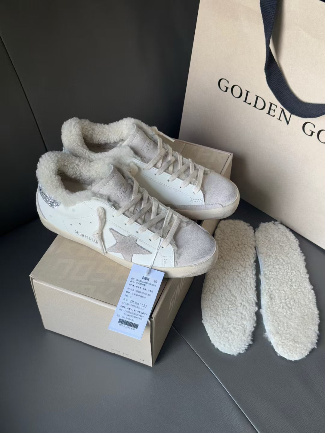 White sneakers with glitter star side panels and plush collars, next to fuzzy shoe liners