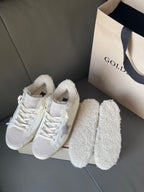 White sneakers with shearling cuffs and glitter star details, with matching plush slippers