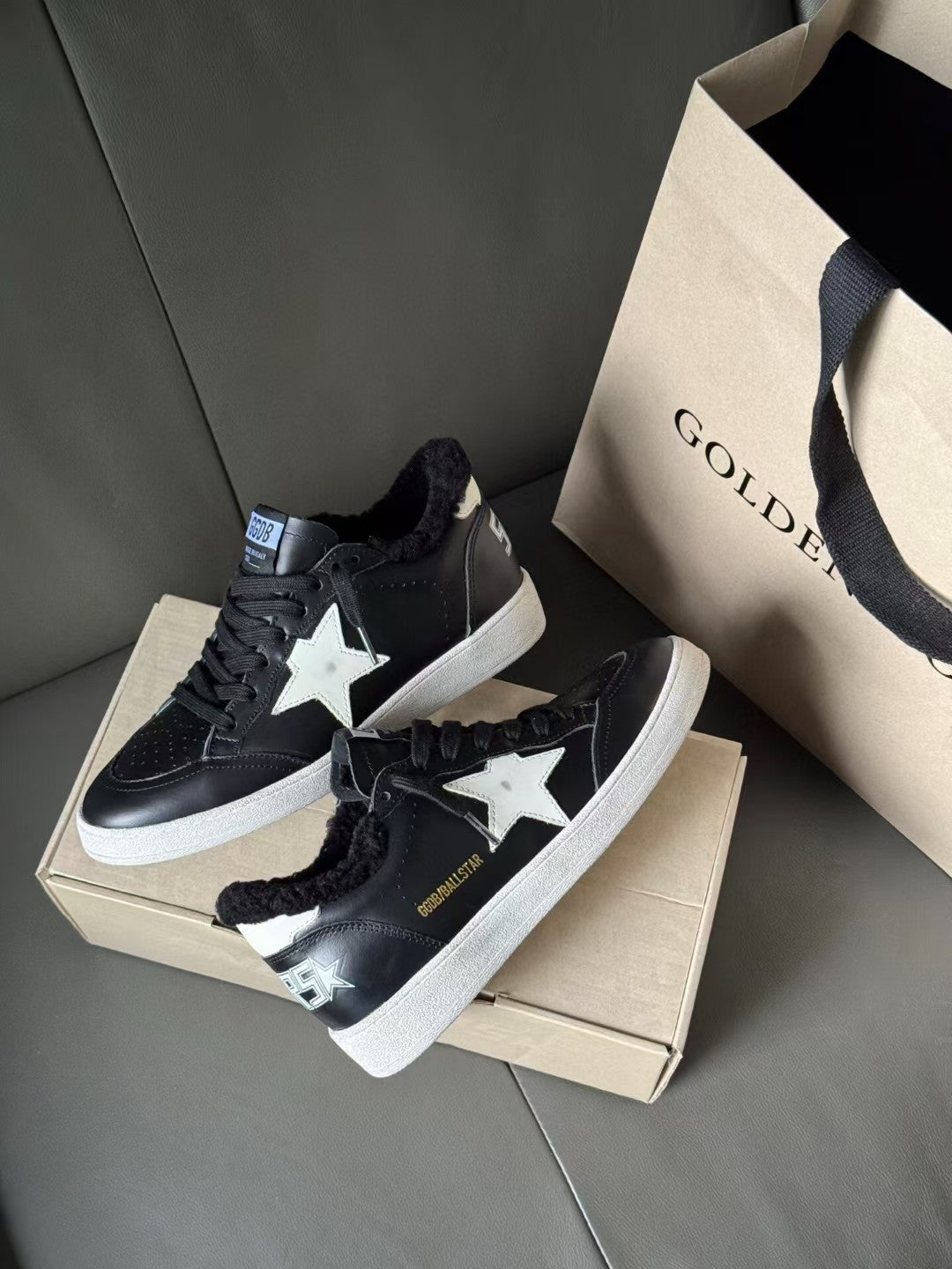 Pair of black low-top sneakers with white star logo and lace-up design