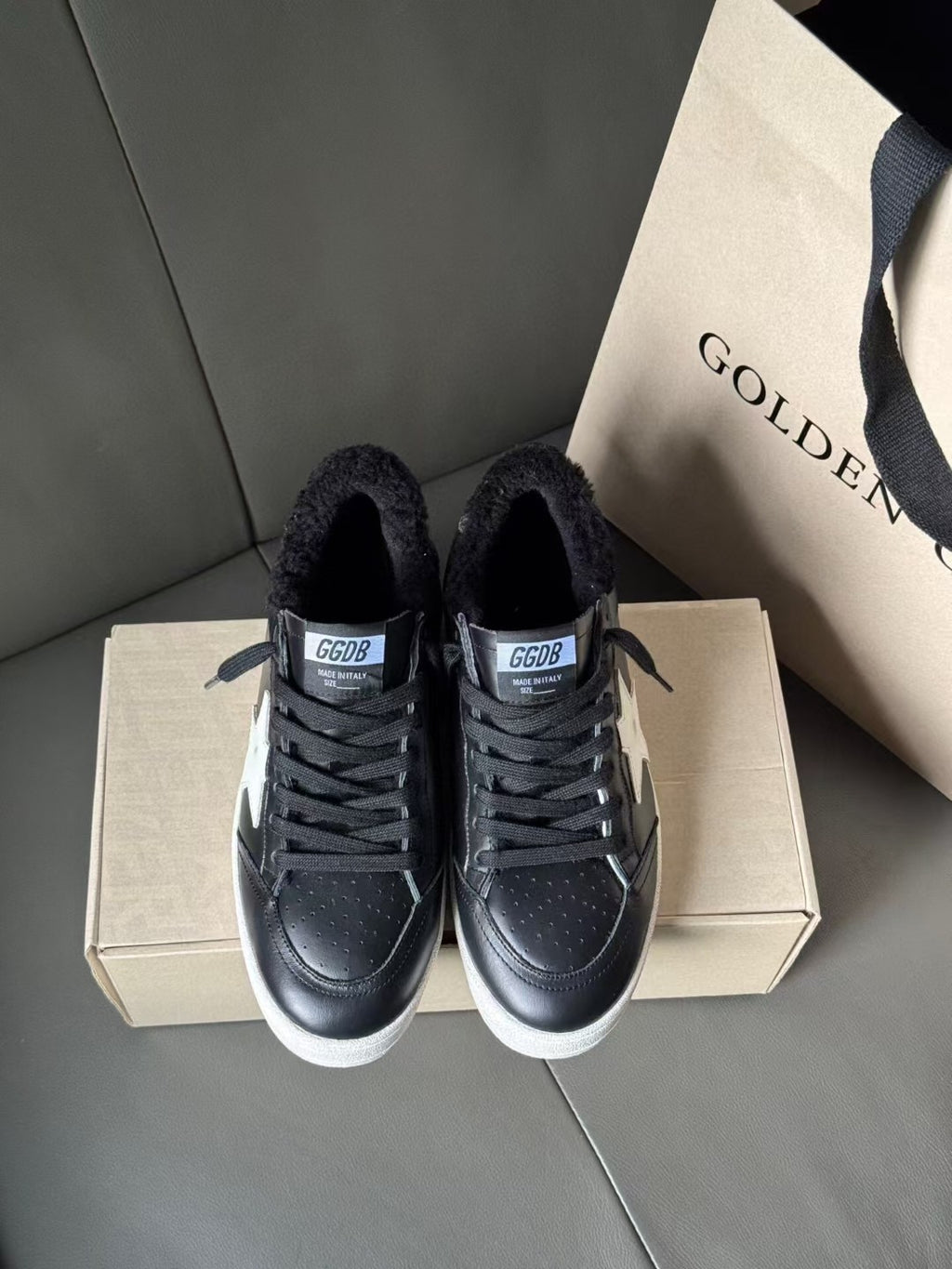 Black lace-up low-top sneakers with textured toe and white rubber sole