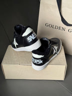 Black high-top sneakers with white rubber sole and star logo on side