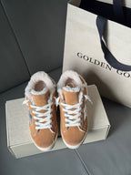 Brown suede high-top sneakers with white shearling trim and blue star logo, shown side by side.
