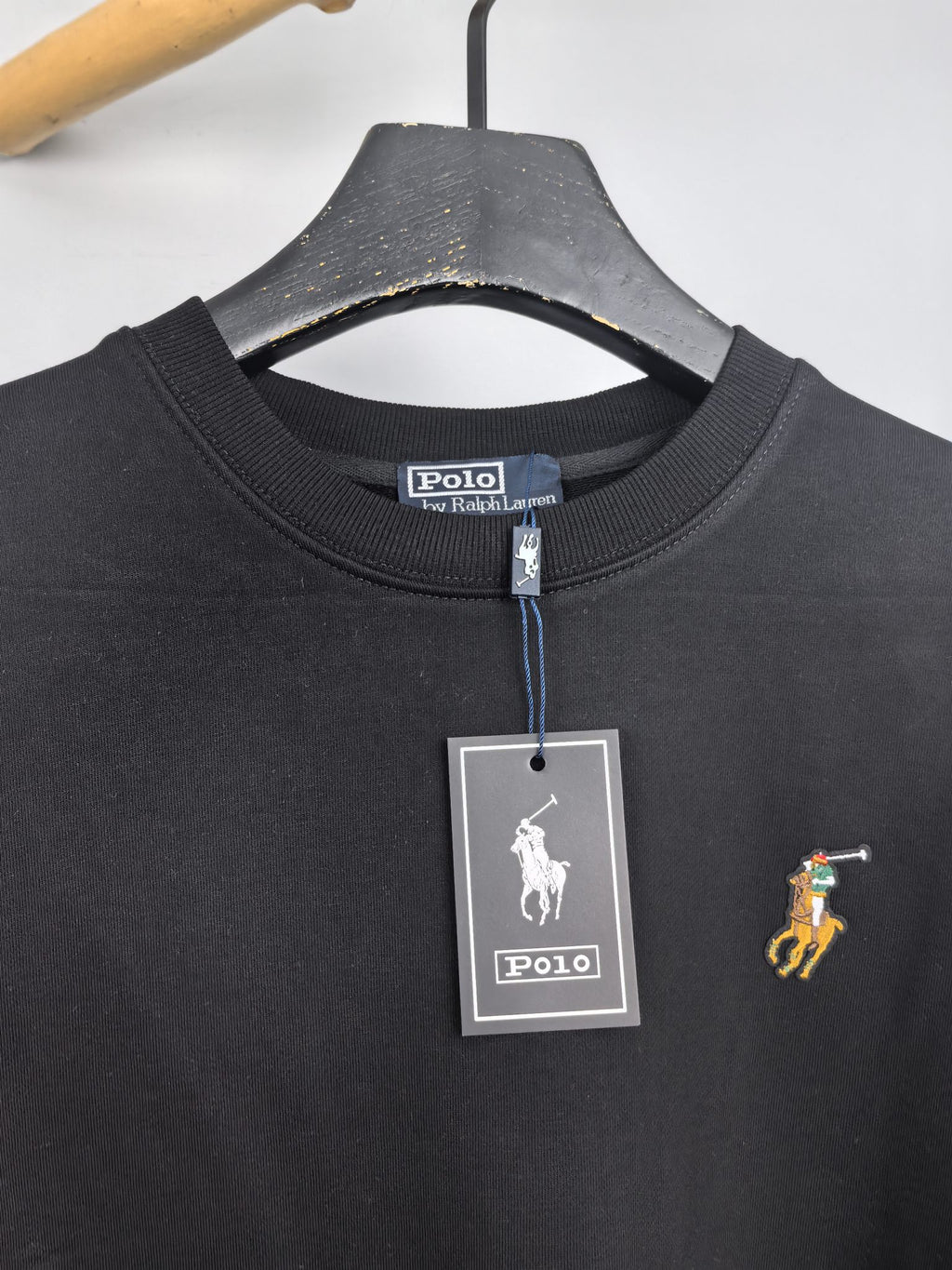 Dark charcoal sweatshirt neckline with Polo Ralph Lauren tag and small pony logo