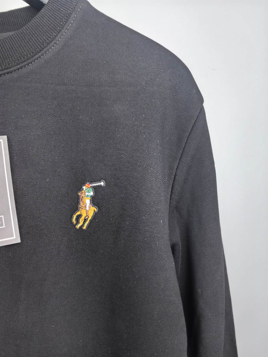 Dark charcoal sweatshirt with small embroidered pony logo on front