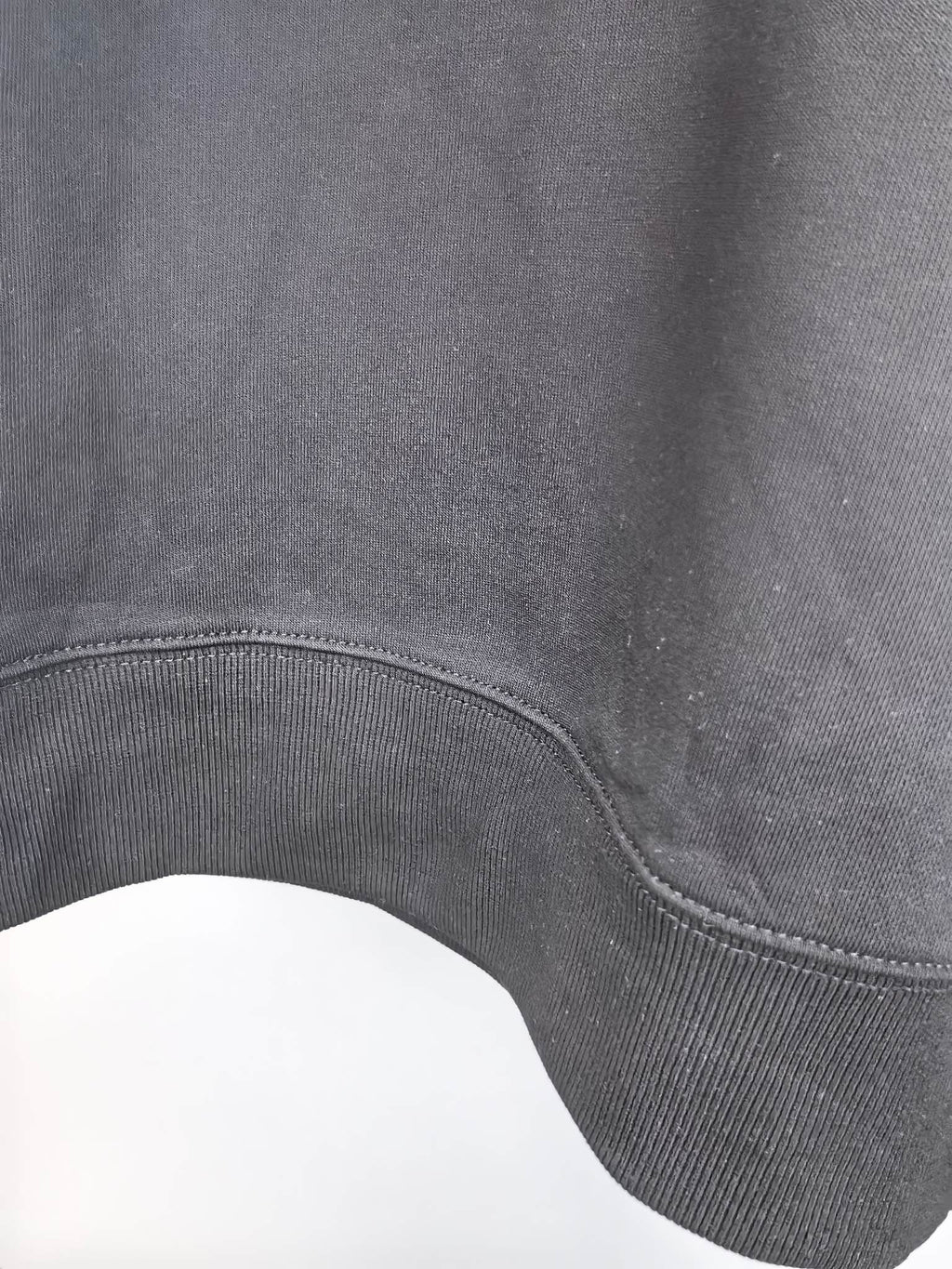 Dark charcoal sweatshirt ribbed hem with curved side opening