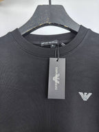 Dark gray crewneck sweatshirt with chest logo and neck tag