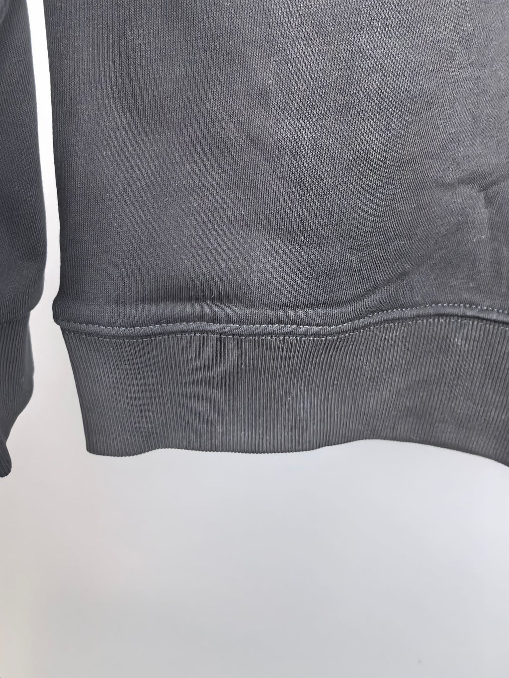 Dark gray crewneck sweatshirt ribbed hem detail