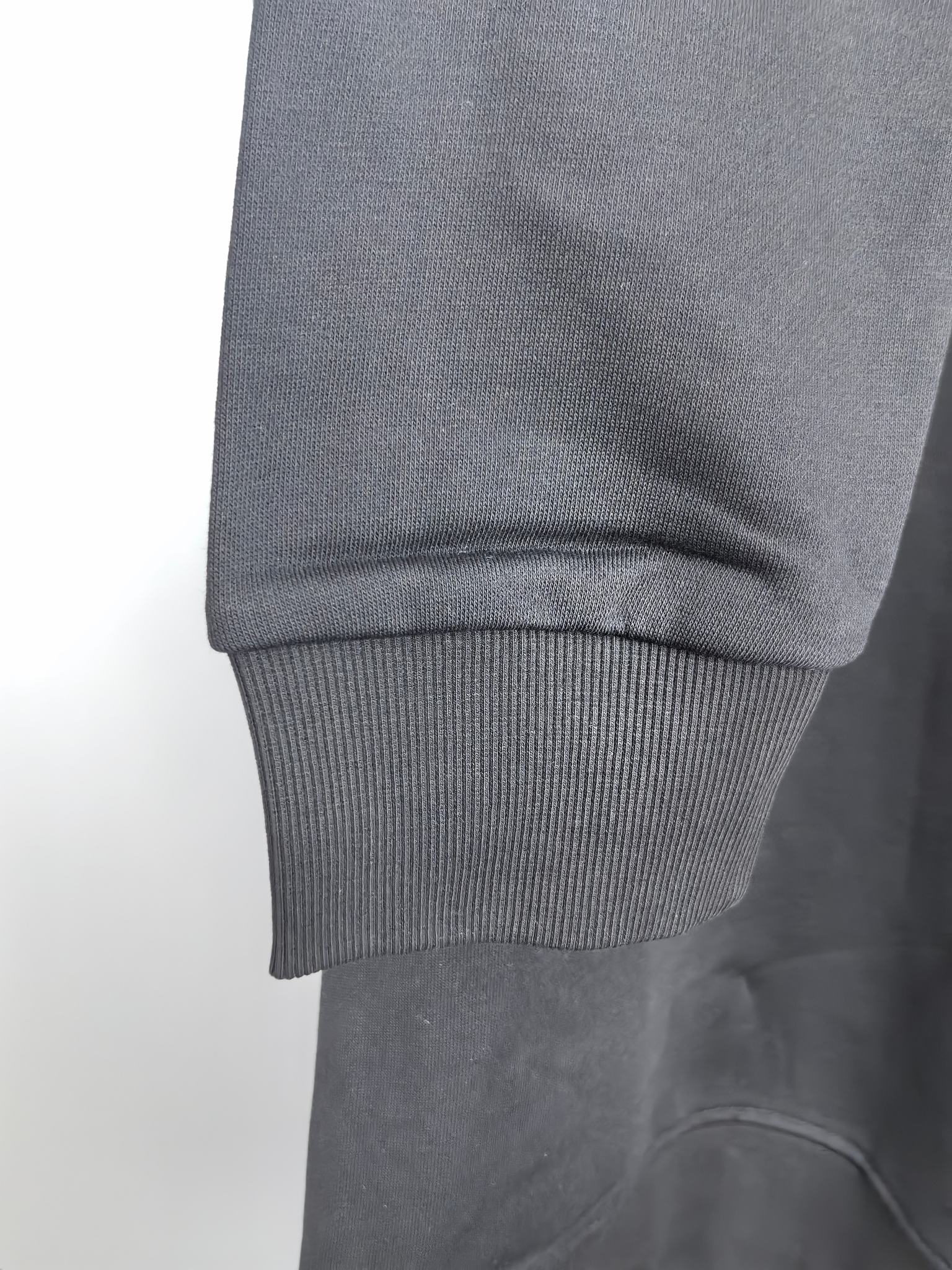 Dark gray crewneck sweatshirt with ribbed cuff and hem